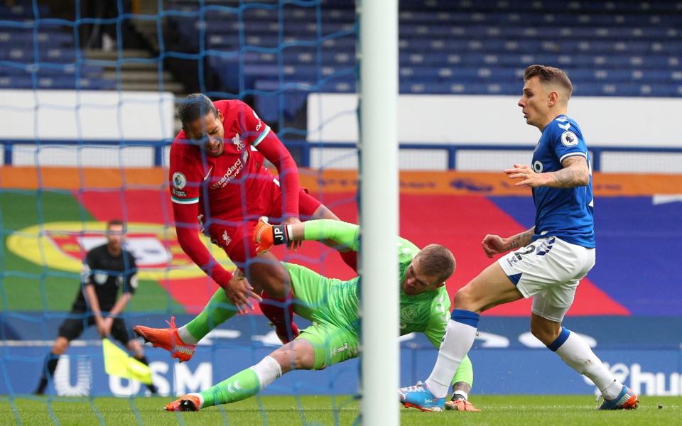 Jordan Pickford challenges Liverpool's Virgil van Dijk during the Premier League match at Goodison Park, - PA