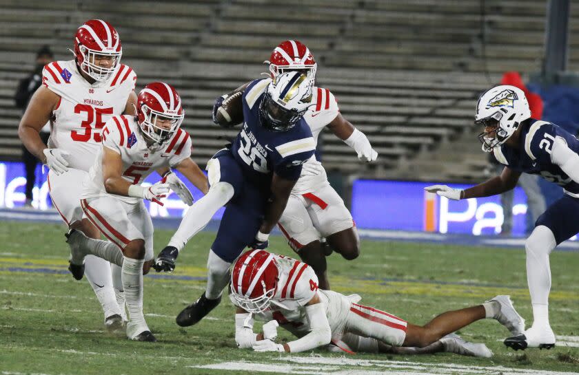 PASADENA, CALIF. - NOV. 25, 2022, St. John Bosco running back Cameron Jones (20) fights fort extra yardage against Mater Dei in the fourth quarter of the CIF Southern Section Championship Game at the Rose Bowl in Pasadena on Friday night, Nov. 25, 2022. Bosco won, 24-22. (Luis Sinco / Los Angeles Times)