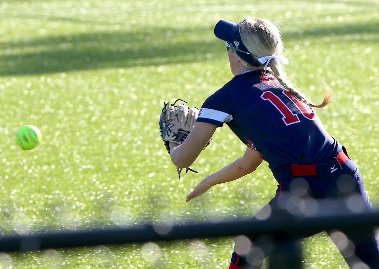 Bedford North Lawrence's Tori Nikirk (16) fields a bouncer back by the warning track on Monday, April 29, 2024.