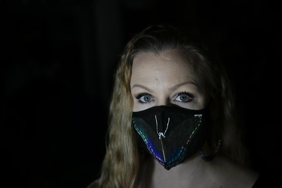 Carey Johnson wears a butterfly face mask in her Germantown, Md., home on Wednesday, Nov. 16, 2022. Carey and her son Fabian Swain have recovered from COVID. (AP Photo/Carolyn Kaster)