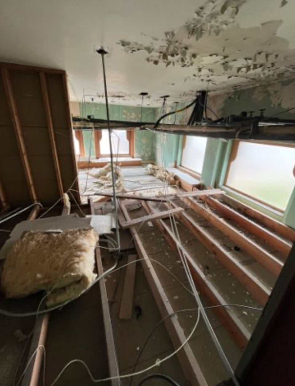 A photo taken during the initial assessment of Historic City Hall's current condition. The image taken above the ceiling reveals windows that the design team wants to expose during the rehabilitation work.