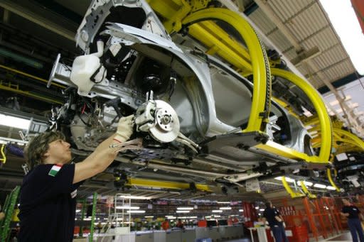 An employee of the Fiat Mirafiori plant works on the assembly line of the Nuova Punto cars in Turin, 2006. Fiat's boss painted a bleak picture of the Italian auto market but said the historic brand will stay in the country, amid union warnings that Italy's top private sector employer is set to shed jobs