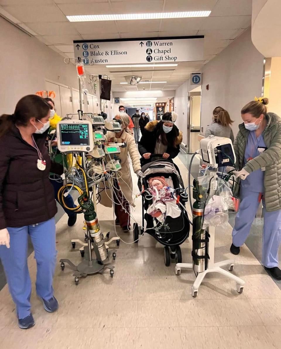 In this photo, mother Ashley Ness, along with staff at Mass General Hospital, are preparing to take baby Chesley May for her only walk outside the building.