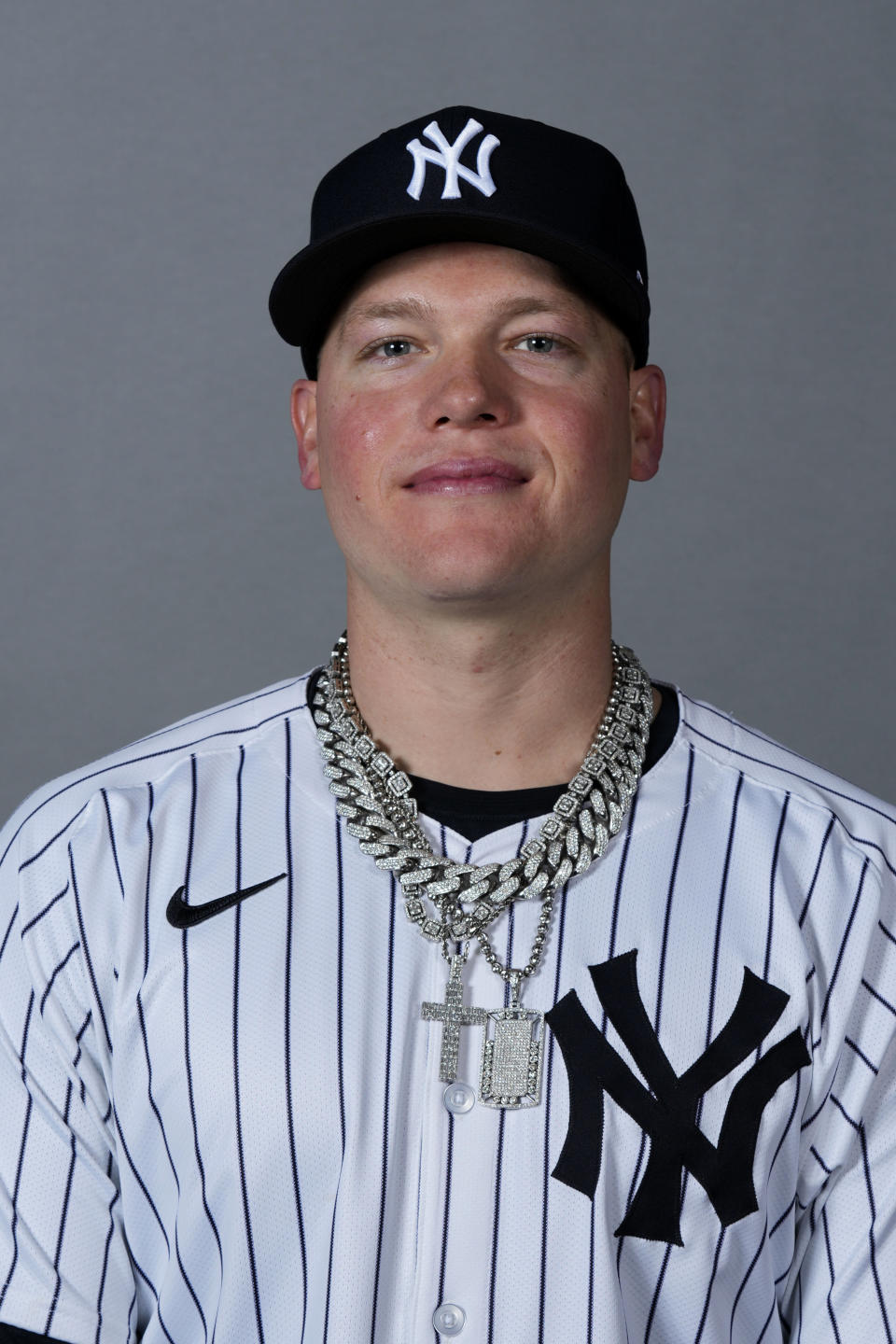 FILE - Alex Verdugo of the New York Yankees baseball team poses Feb. 21, 2024, in Tampa, Fla. During his time with the Boston Red Sox, Alex Verdugo frequently played with several gaudy chains bouncing around his neck. He packs at least six for every road trip, and he's lost count of how many he owns. In his first season with the famously clean-cut New York Yankees, Verdugo has been given an order by manager Aaron Boone: only one chain per game. (AP Photo/Charlie Neibergall, File)