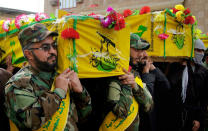 FILE - In this Tuesday, Dec. 29, 2015 file photo, mourners carry the coffins of four militia members of a Shiite group, Nujaba movement of Islamic Resistance, during their funeral procession in the Shiite holy city of Najaf, 100 miles (160 kilometers) south of Baghdad, Iraq. Aleppo is set to be recaptured by Syrian President Bashar Assad, but the victory will not be Assad's alone. The battle for Syria's largest city has attracted thousands of foreign forces, including Russian soldiers and thousands of fighters from Iran, Lebanon, Iraq and Afghanistan. (AP Photo/Anmar Khalil, File)