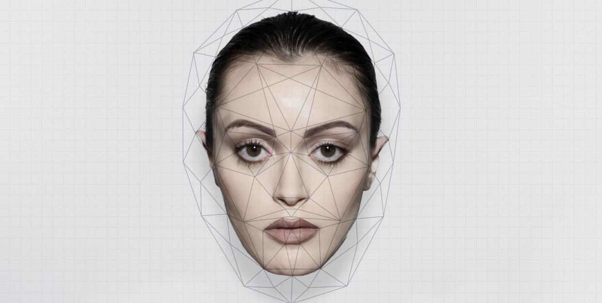 face recognition analyzing on woman's face over white background