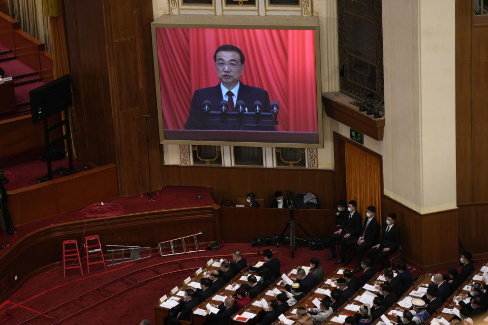 Chinese Premier Li Keqiang is shown on a large video screen as he speaks during the opening session of China's National People's Congress (NPC) at the Great Hall of the People in Beijing, Sunday, March 5, 2023. (AP Photo/Ng Han Guan)