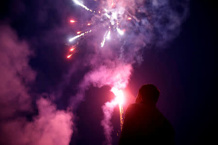 FILE PHOTO: A worker watches fireworks at a fireworks manufactory in Liuyang, Hunan province, China January 29, 2018. REUTERS/Aly Song/File Photo