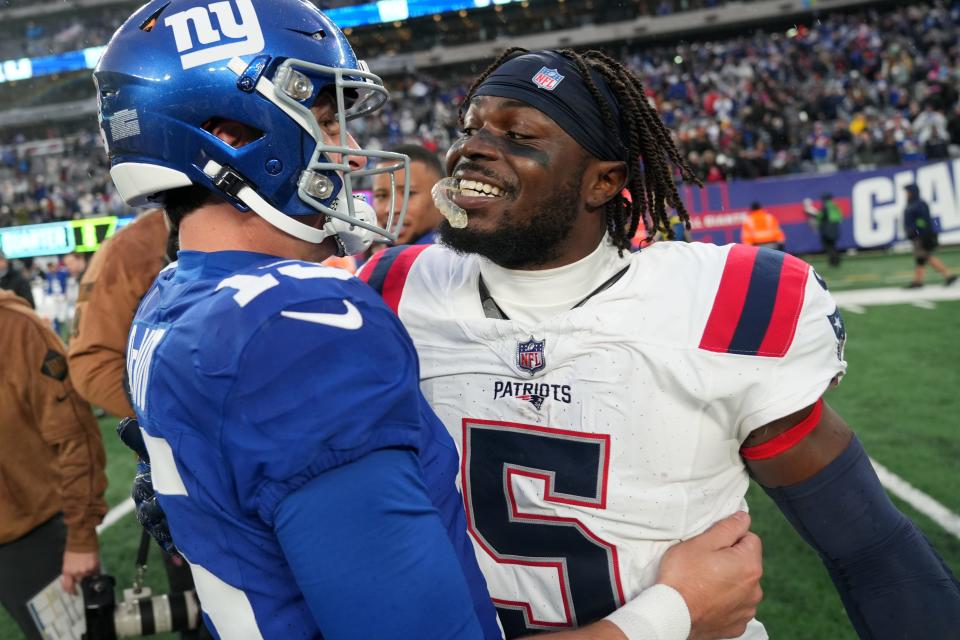 New England Patriots safety Jabrill Peppers (5) congratulates New York Giants quarterback Tommy DeVito (15) after the quarterback won the first game he started in the NFL, 10-7, Sunday, November 26, 2023.