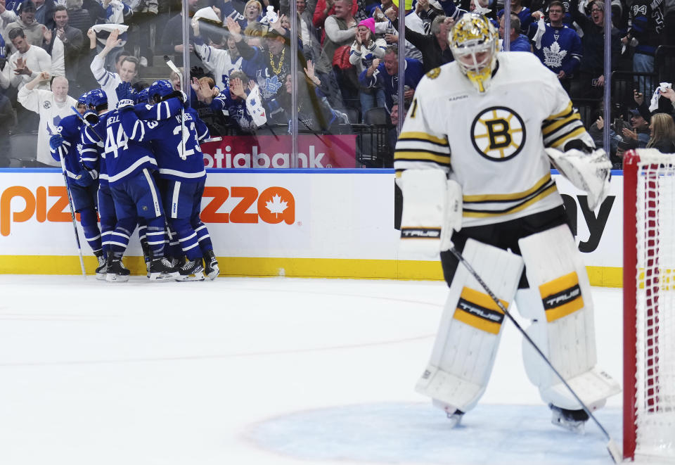 Toronto Maple Leafs players, back left, celebrate after William Nylander's goal as Boston Bruins goaltender Jeremy Swayman, right, looks on during second-period action in Game 6 of an NHL hockey Stanley Cup first-round playoff series in Toronto, Thursday, May 2, 2024. (Nathan Denette/The Canadian Press via AP)