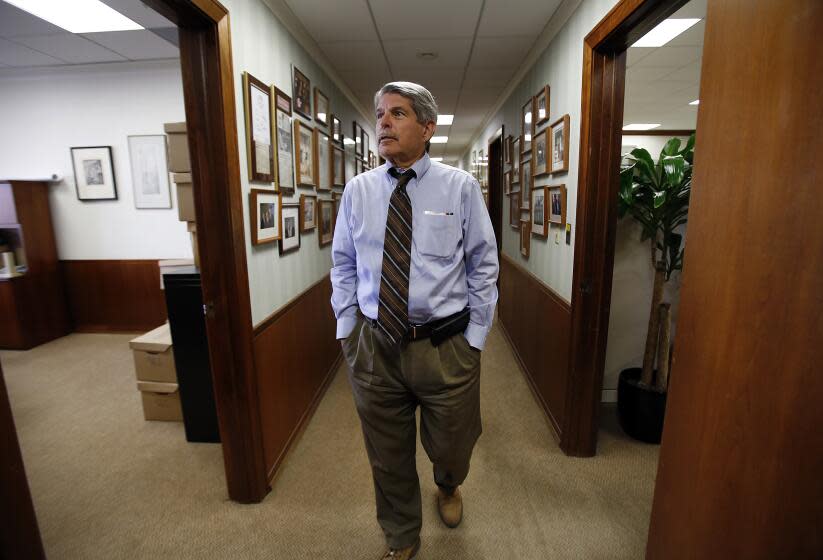 LOS ANGELES, CA NOVEMBER 20, 2014 -- Zev Yaroslavsky, member of the Los Angeles County Board of Supervisors walks the long hallway filled with photographs and newspaper clips chronicling his career in his County Hall of Administration office on November 20, 2014 as he is preparing to leave the office he was elected to in 1994. Yaroslavsky served on the Los Angeles City Council from 1975 to 1994 and has been active in the areas of transportation, the environment, health care and cultural affairs. (Al Seib / Los Angeles Times)