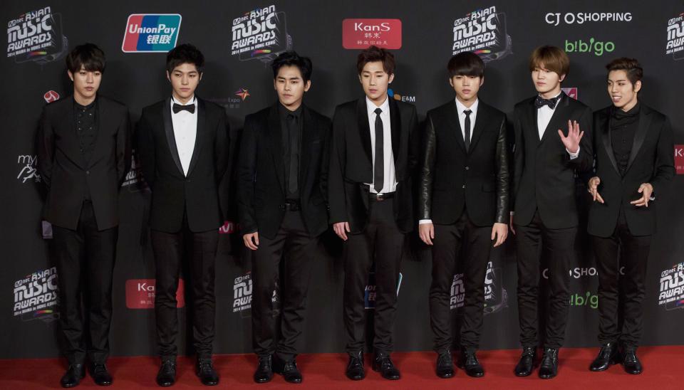 Members of South Korean pop band Infinite pose on the red carpet as they attend the 2014 Mnet Asian Music Awards (MAMA) in Hong Kong