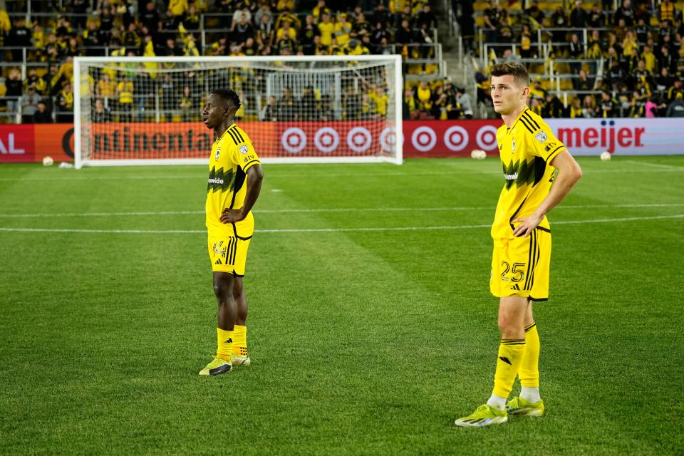 Crew midfielders Yaw Yeboah (14) and Sean Zawadzki stand at midfield following Saturday's loss to Cincinnati.