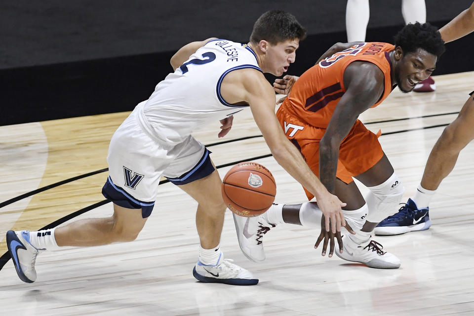 Villanova's Collin Gillespie, left, knocks the ball from Virginia Tech's Tyrece Radford during the first half of an NCAA college basketball game Saturday, Nov. 28, 2020, in Uncasville, Conn. (AP Photo/Jessica Hill)