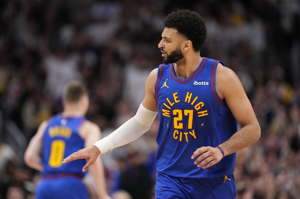 Denver Nuggets guard Jamal Murray celebrates after a 3-point basket against the Los Angeles Lakers during the first half in Game 1 of an NBA basketball first-round playoff series Saturday, April 20, 2024, in Denver. (AP Photo/Jack Dempsey)