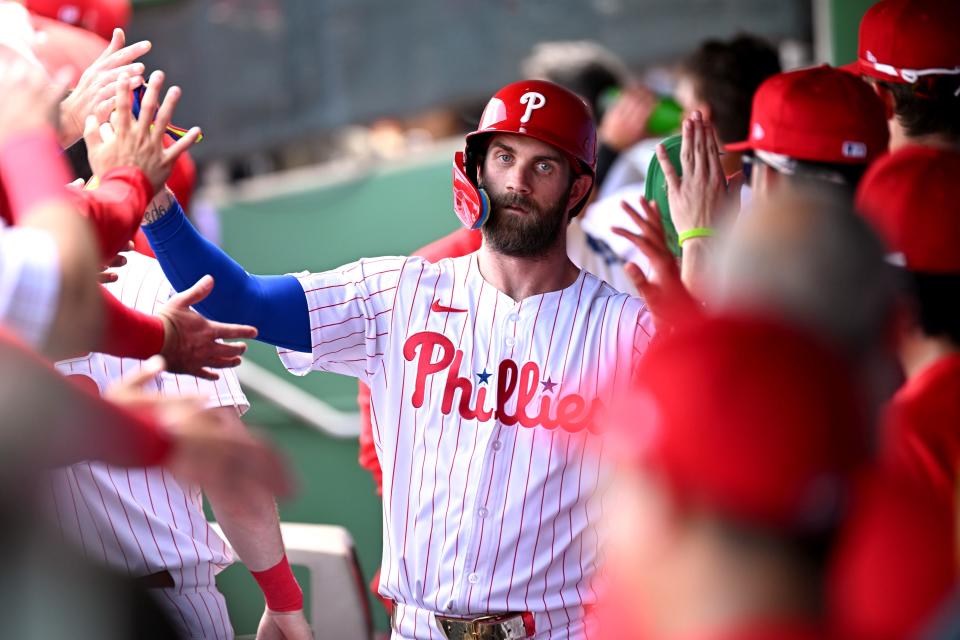 Philadelphia Phillies first baseman Bryce Harper (3) celebrates with his teammates after scoring a run in the first inning of the spring training game against the Houston Astros at BayCare Ballpark on March 8.