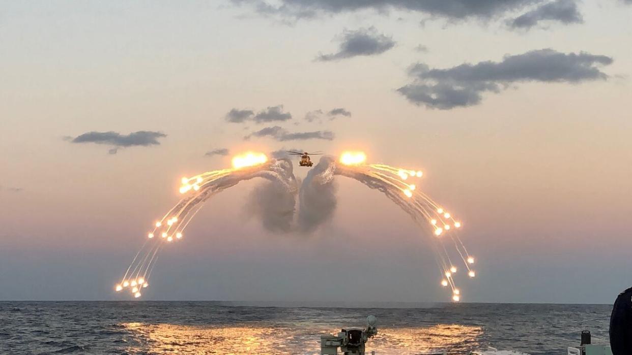 A Royal Canadian navy CH-148 Cyclone helicopter deploys flares during a training exercise in an undisclosed location in November 2022. (Royal Canadian Navy/Twitter - image credit)