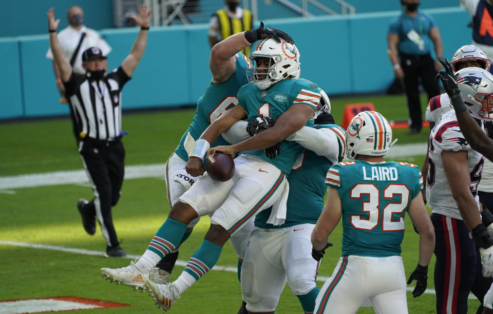 Miami Dolphins quarterback Tua Tagovailoa (1) celebrates his score against the New England Patriots during the second half of an NFL football game Sunday, Dec. 20, 2020, in Tampa, Fla. (AP Photo/Chris O'Meara)