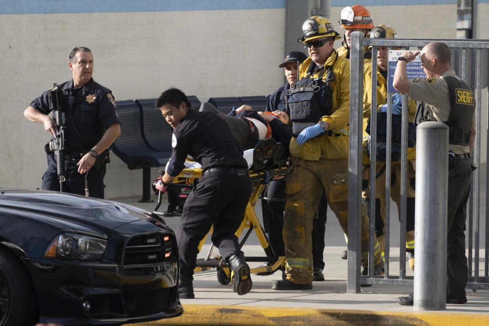 Emergency personnel remove an injured person following a shooting at Saugus High School, Thursday, Nov. 14, 2015 in Santa Clarita, Calif. (David Crane/The Orange County Register via AP)