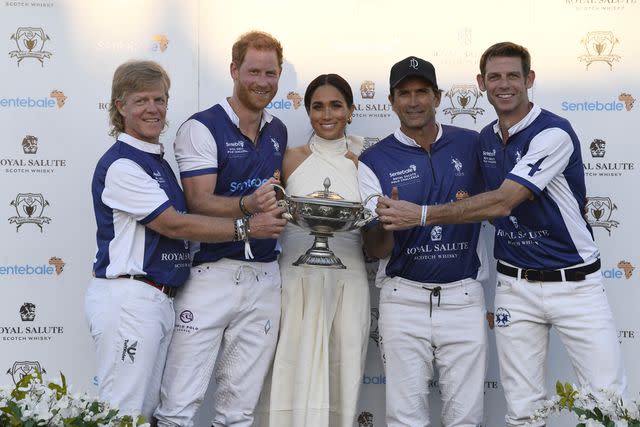 <p>Jason Koerner/Getty</p> Prince Harry (second from left) and Meghan Markle (center) attend the Royal Salute Polo Challenge in Florida on April 12, 2024.