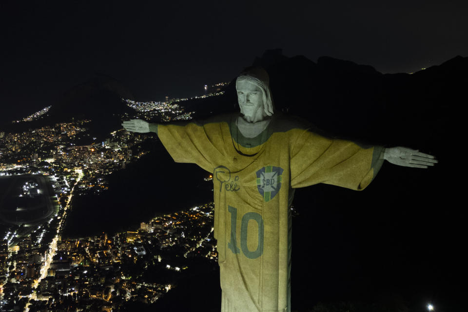 The Christ the Redeemer statue is illuminated with an image of Pele's Brazilian jersey, as a tribute to the soccer legend on his one-year death anniversary, in Rio de Janeiro, Brazil, Friday, Dec. 29, 2023. (AP Photo/Bruna Prado)