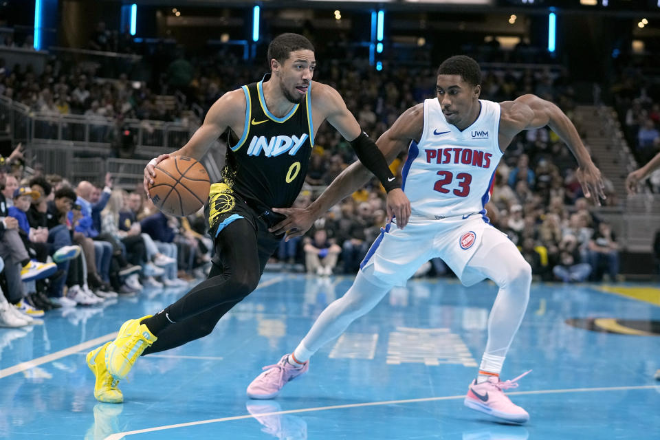 Indiana Pacers' Tyrese Haliburton (0) goes to the basket against Detroit Pistons' Jaden Ivey (23) during the first half on an NBA In-Season Tournament basketball game, Friday, Nov. 24, 2023, in Indianapolis. (AP Photo/Darron Cummings)