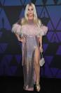 Singer Kesha pulled out all the stops in this iridescent dress by Cheng, featuring a pink feather embellishment. Hollywood, November 18, 2018