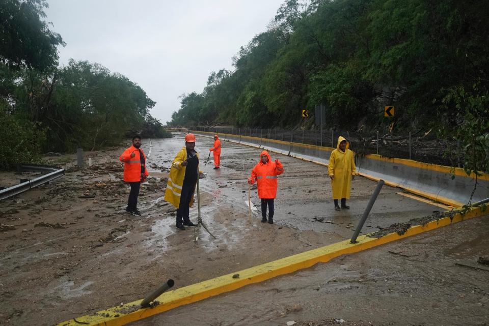 Workers clear a blocked highway after the passing of Hurricane Otis near Acapulco, Mexico, Wednesday, Oct. 25, 2023 (AP)