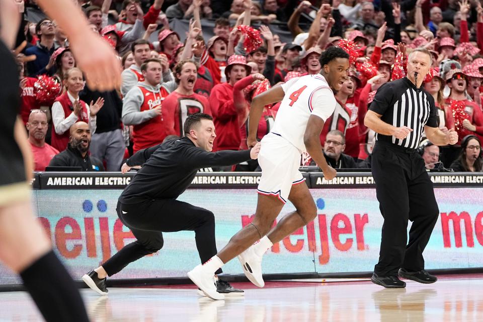 Feb 18, 2024; Columbus, Ohio, USA; Ohio State Buckeyes interim head coach Jake Diebler celebrates a three pointer by guard Dale Bonner (4) during the second half of the NCAA men’s basketball game against the Purdue Boilermakers at Value City Arena. Ohio State won 73-69.