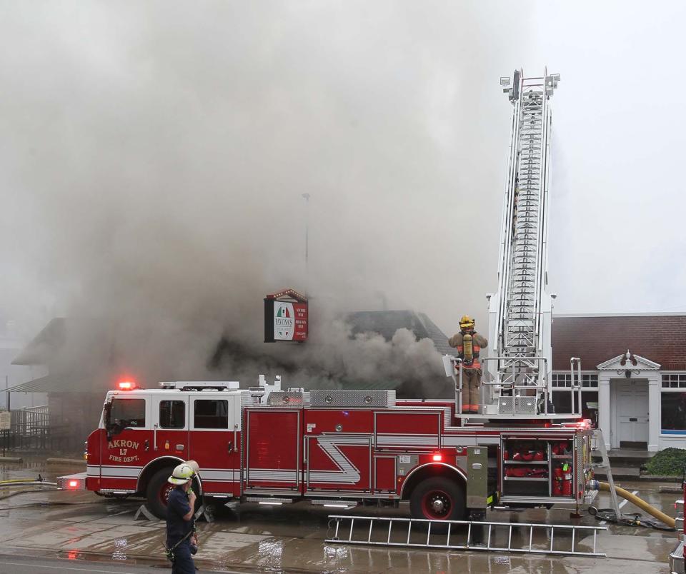 Akron Fire Department ladder trucks poured water on a blaze at Pavona's Pizza Joint for more than two hours Friday.