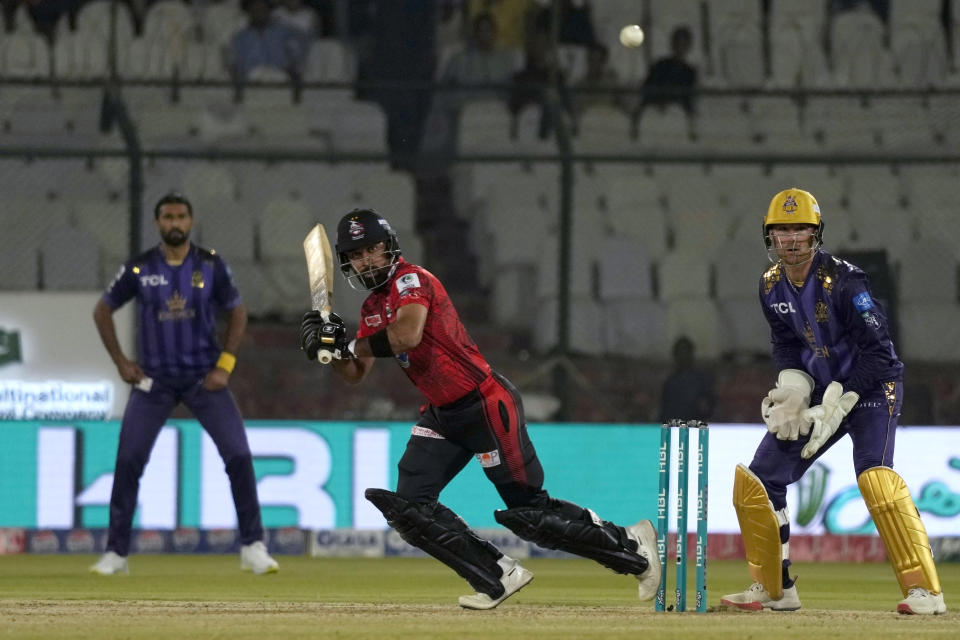 Lahore Qalandars' Abdullah Shafique, center, plays a shot during the Pakistan Super League T20 cricket match between Lahore Qalandars and Quetta Gladiators, in Karachi, Pakistan, Sunday, March 10, 2024. (AP Photo/Fareed Khan)