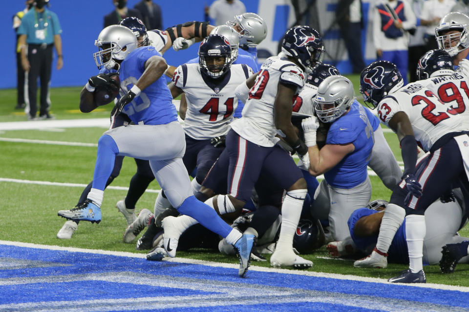 Detroit Lions running back Adrian Peterson breaks through the Houston Texans defense for a 1-yard touchdown run during the first half of an NFL football game, Thursday, Nov. 26, 2020, in Detroit. (AP Photo/Duane Burleson)