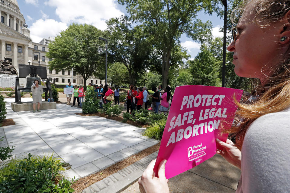 An abortion rights advocate holds signage at the Capitol in Jackson, Miss., voicing her opposition to state legislatures passing abortion bans that prohibit most abortions once a fetal heartbeat can be detected, Tuesday, May 21, 2019. The rally in Jackson was one of many around the country to protest abortion restrictions that states are enacting. (AP Photo/Rogelio V. Solis)