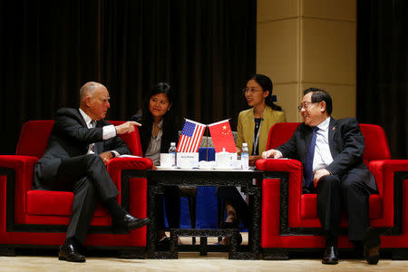 California Governor Jerry Brown meets with Chinese Minister of Science and Technology Wan Gang at the International Forum on Electric Vehicle Pilot Cities and Industrial Development in Beijing, China June 6, 2017. REUTERS/Thomas Peter