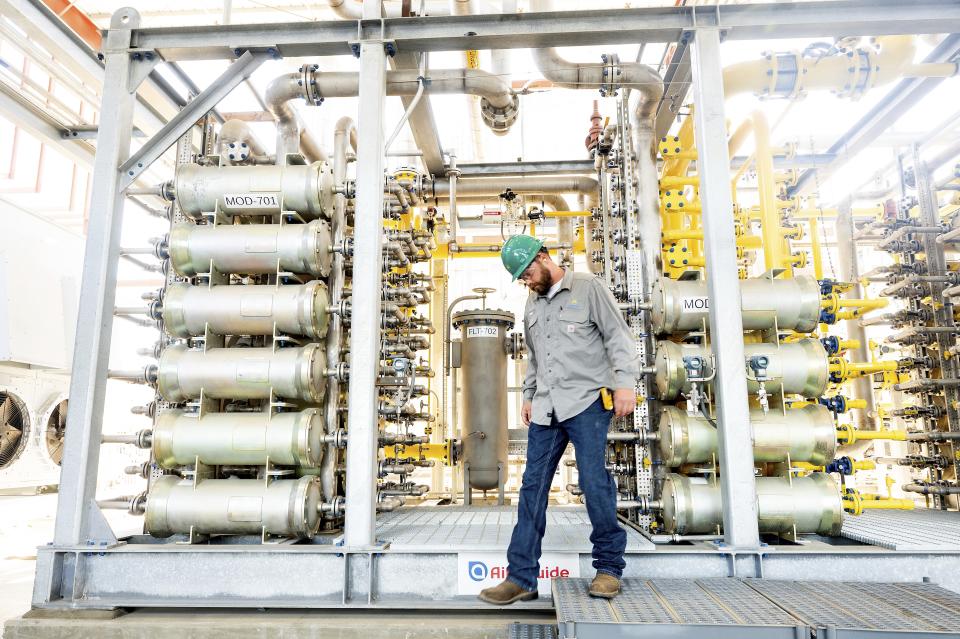 Andrew Zipser checks operations at an Aemetis biogas facility in Ceres, Calif., on Thursday, May 9, 2024. Local dairies use digesters to capture methane from cow manure which is then piped to the facility for processing. (AP Photo/Noah Berger)