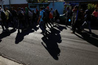 People walk in a caravan of migrants departing from El Salvador en route to the United States, in San Salvador, El Salvador, November 18, 2018. REUTERS/Jose Cabezas