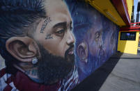 A street mural of the late rapper Nipsey Hussle is pictured near his closed The Marathon Clothing store, Thursday, June 30, 2022, in Los Angeles. The many murals of Hussle around Los Angeles speak to the late rapper's lasting legacy. (AP Photo/Chris Pizzello)