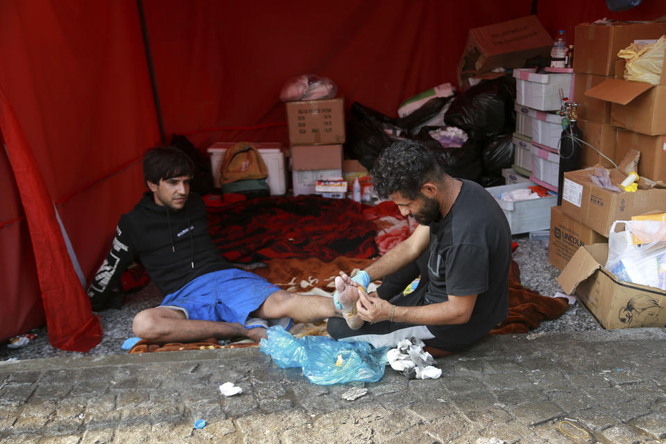 Anti-government protesters rest during sit-in at Tahrir Square in Baghdad, Iraq, Wednesday, Oct. 30, 2019. Anti-government protests in Iraq gained momentum Wednesday with tens of thousands of people gathered in a central square in Baghdad and across much of the country's Shiite-majority central southern provinces. (AP Photo/Hadi Mizban)