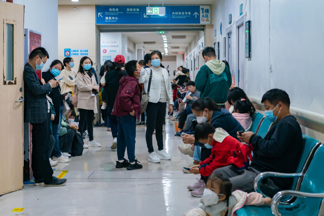 Parents with children suffering from respiratory diseases line up at a children's hospital in Chongqing, China, last week. (Getty)