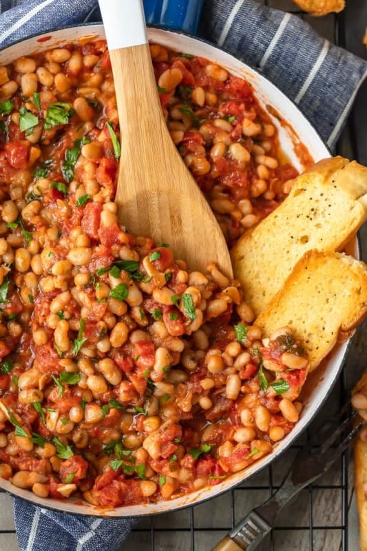 <p>The Cookie Rookie</p><p>This white beans recipe is so simple, yet so delicious! Cannellini beans cooked with tomatoes, garlic, and chicken broth make for one tasty side dish. It’s perfect for holidays or easy weeknight meals!</p><p><strong>Get the recipe: <a href="https://www.thecookierookie.com/white-beans-recipe/" rel="nofollow noopener" target="_blank" data-ylk="slk:Cannellini Beans with Tomatoes and Garlic;elm:context_link;itc:0;sec:content-canvas" class="link rapid-noclick-resp"><em>Cannellini Beans with Tomatoes and Garlic</em></a></strong></p>