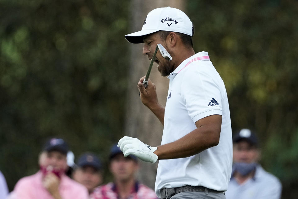 Xander Schauffele bites his club after taking his second tee shot on the 16th hole during the final round of the Masters golf tournament on Sunday, April 11, 2021, in Augusta, Ga. His first tee shot went into the water. (AP Photo/Charlie Riedel)