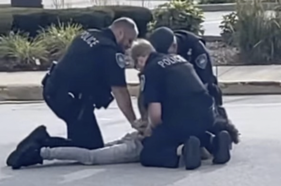 Officers from the Oak Lawn police department kneel on a teen suspect (Myriah Deal)