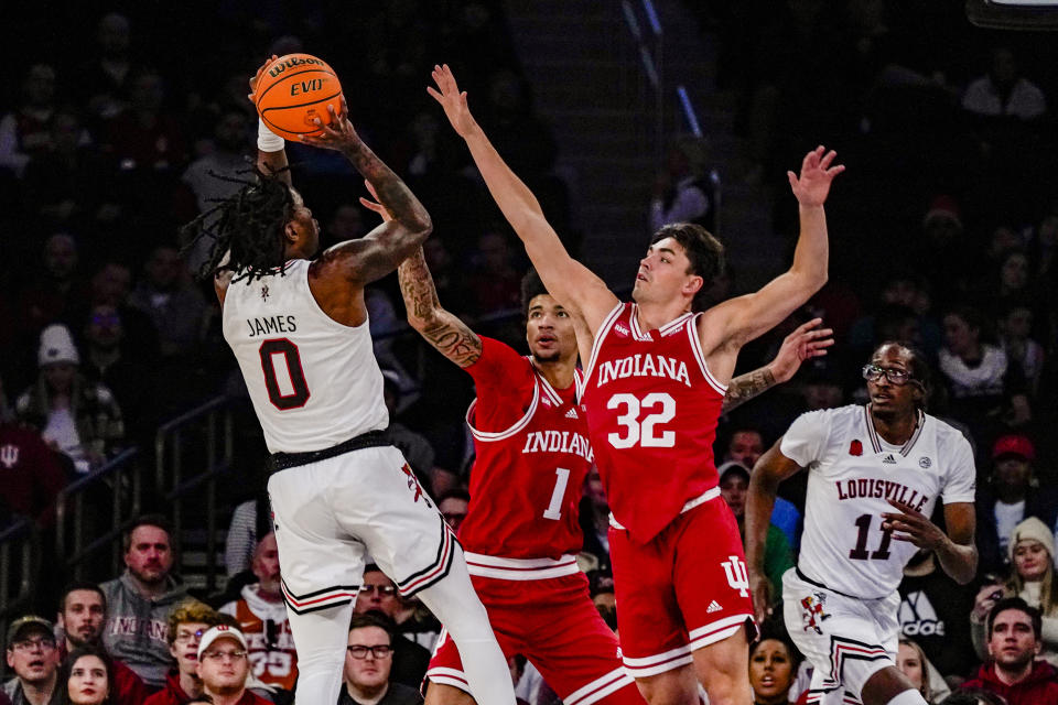 Louisville guard Mike James (0) shoots the ball over Indiana's Trey Galloway (32) and Kel'el Ware (1) in an NCAA college basketball game in the Empire Classic tournament in New York, Monday, Nov. 20, 2023. (AP Photo/Peter K. Afriyie)