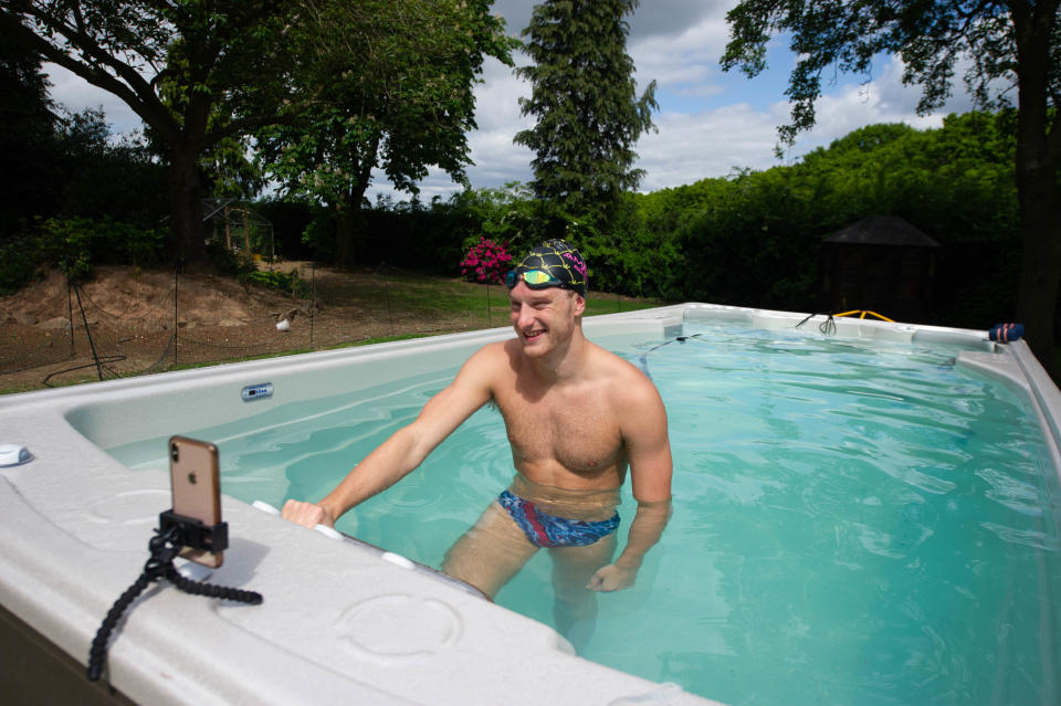 British swimmer Luke Greenbank trains at pool in Ed Baxter's home in Loughborough watched by coach Mel Marshall. The pool was provided by Jacuzzi in partnership with Bedfordshire Hot Tubs to allow GB Olympic Swimmers to continue to train at home for Tokyo 2021 during the current UK lockdown.