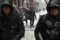 Pedestrians walk through a snow storm in New York March 5, 2015. REUTERS/Lucas Jackson