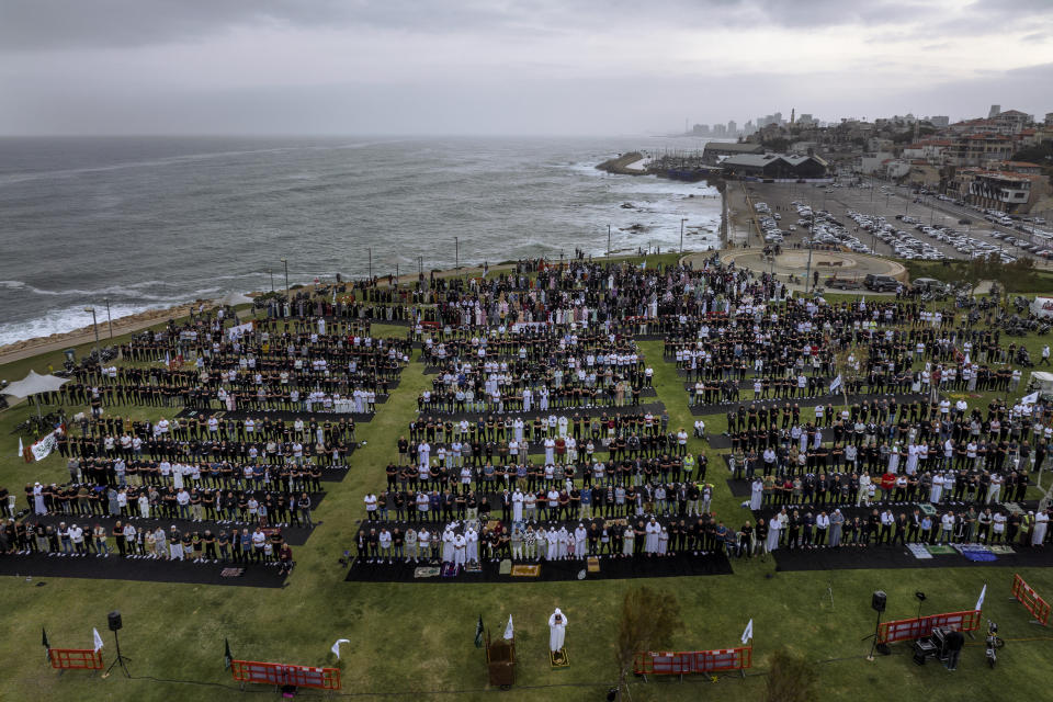 Muslim worshippers offer Eid al-Fitr prayer at a park in the mixed Arab Jewish city of Jaffa, near Tel Aviv, Israel, Monday, May 2, 2022. Muslims around the world celebrate the end of the holy fasting month of Ramadan. (AP Photo/Oded Balilty)