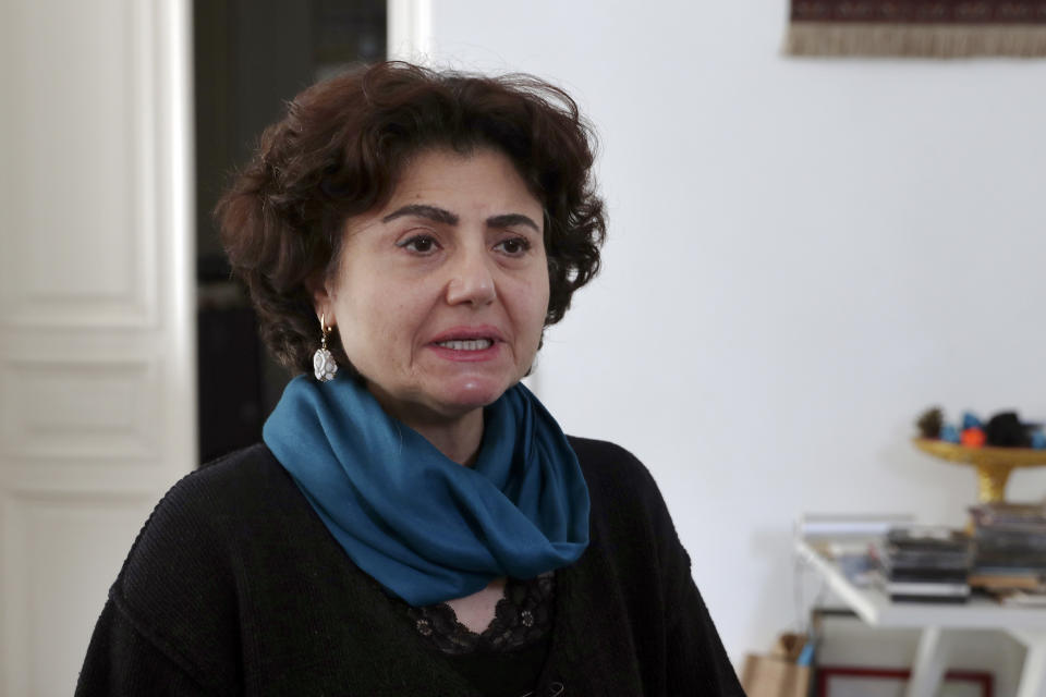 Rasha, sister of Lokman Slim, a longtime Shiite political activist and researcher, who has been found dead in his car, speaks to journalists at her house in the southern Beirut suburb of Dahiyeh, Lebanon, Thursday, Feb. 4, 2021. (AP Photo/Bilal Hussein)