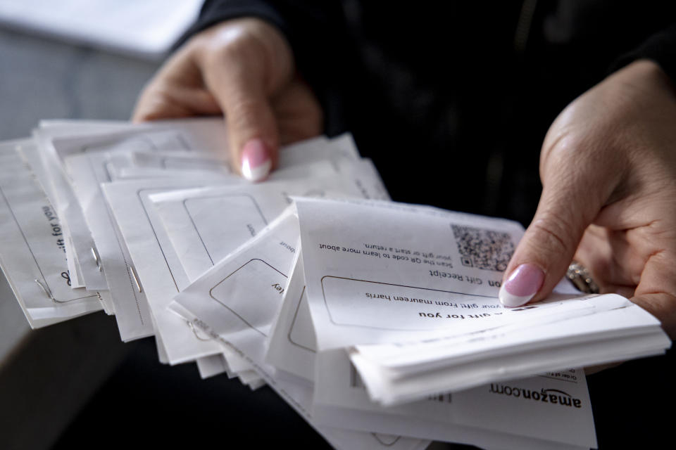 Karen Sandone holds receipts for donations she has received for an Alzheimer's disease fundraiser she is hosting. (Rachel Wisniewski for The Washington Post)