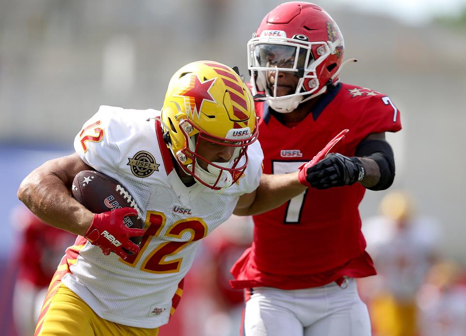  Philadelphia Stars receiver Chris Rowland runs for a gain in the fourth quarter  with defense from New Jersey Generals Dravon Askew-Henry.