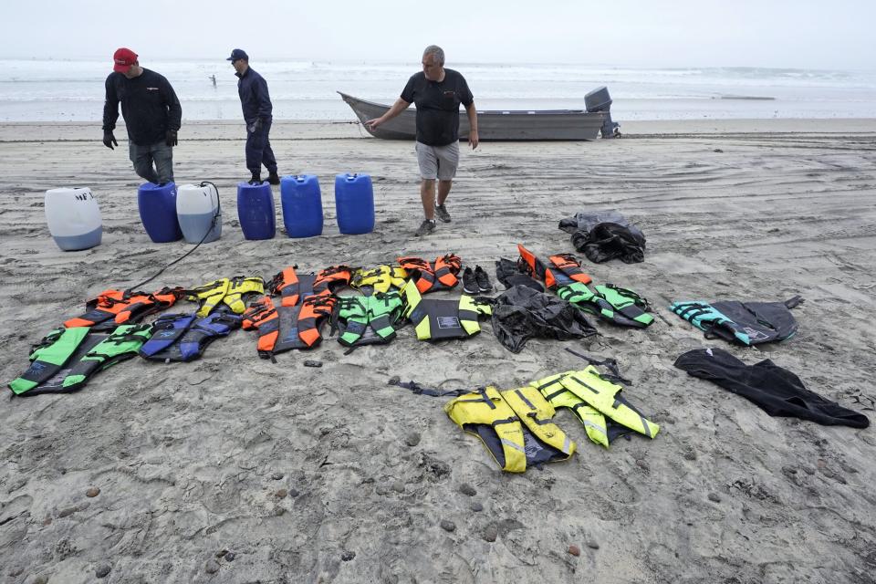 Boat salvager Robert Butler, right, and KC Ivers, left, pick up items in front of one of two boats on Blacks Beach, in San Diego. Authorities say multiple people were killed when two suspected smuggling boats overturned off the coast in San Diego, and crews were searching for additional victims California Boat Deaths, San Diego, United States - 12 Mar 2023